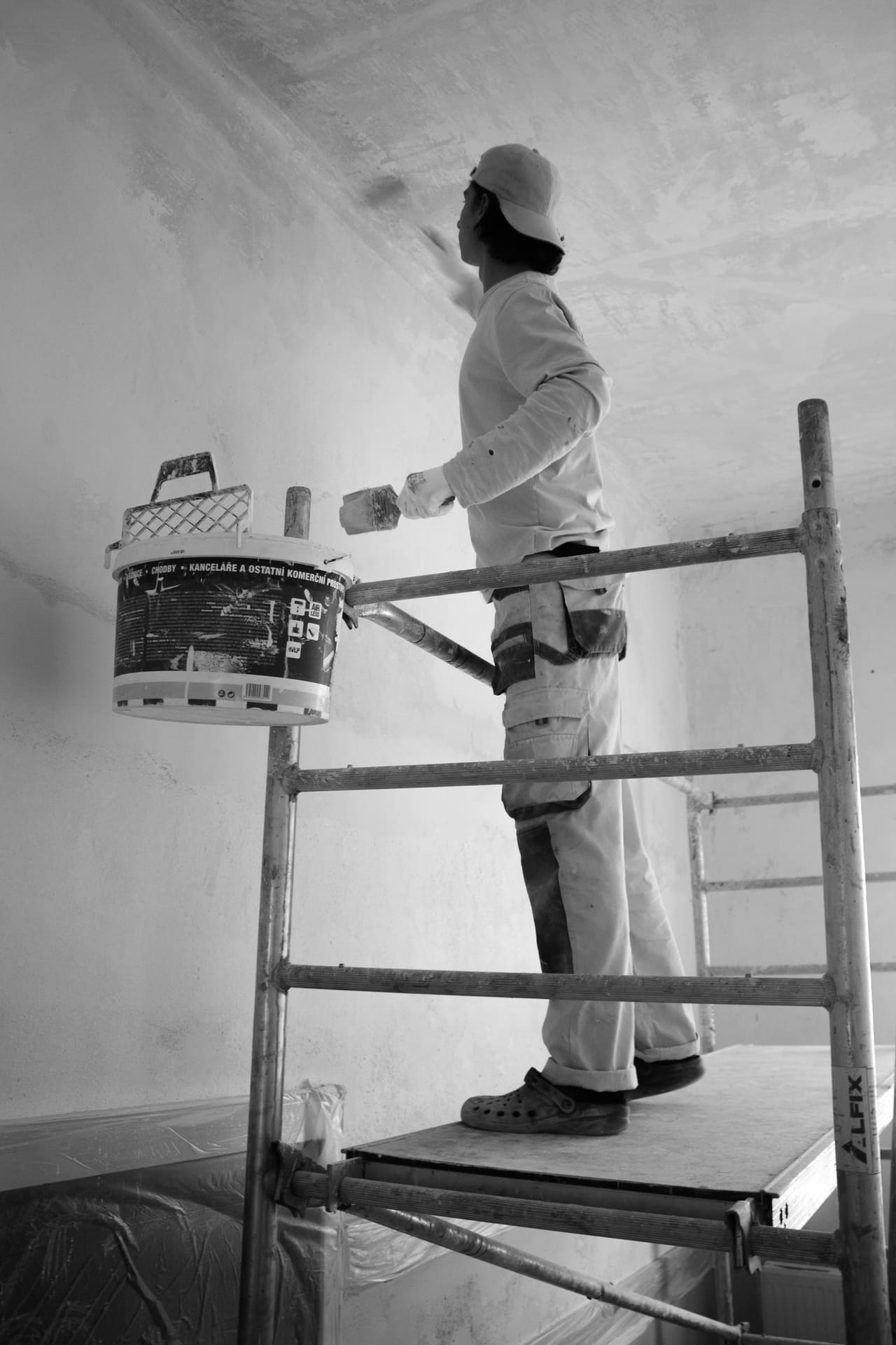 Tradesman finishing an interior wall